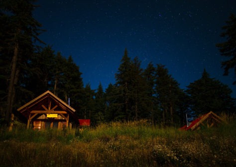 Night sky above a cabin