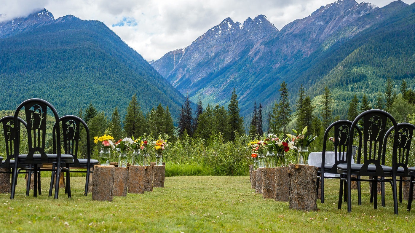 Outdoor wedding ceremony setup with the woods and mountains in the background