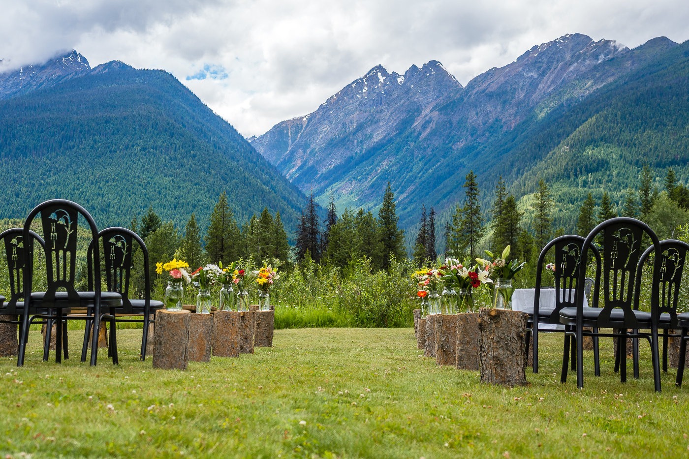 Outdoor wedding ceremony setup with the woods and mountains in the background