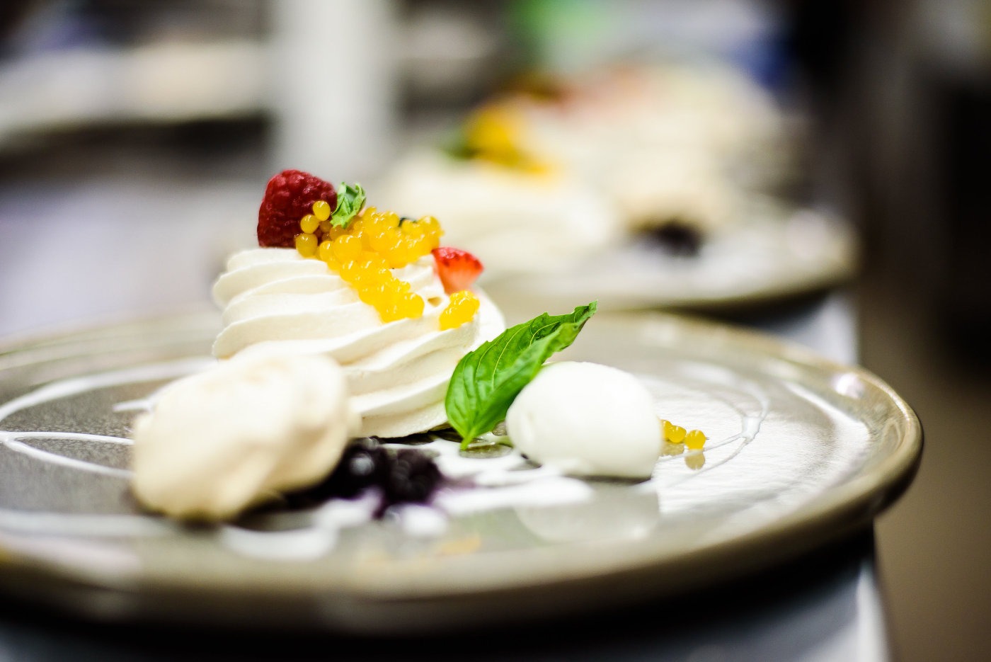 Plated desert with small fruit and mint garnish