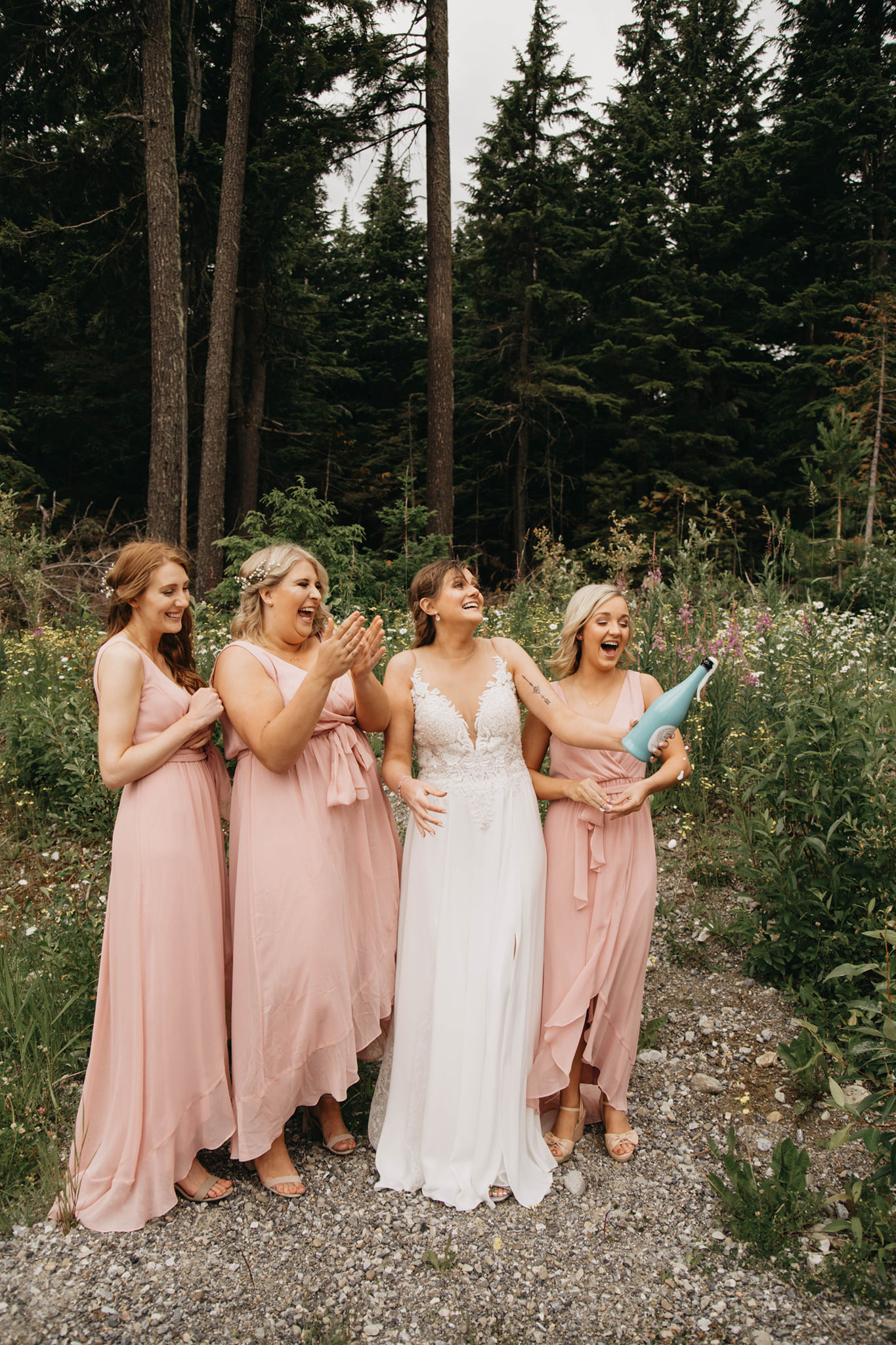bride and bridal party popping champagne at wedding near heather mountain lodge